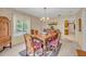 Traditional dining room features a wood table and chairs, chandelier, and a view to the kitchen at 1115 Lake Francis Dr, Apopka, FL 32712