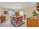 Traditional dining room featuring a wood table, patterned rug, chandelier and decorative wallpaper at 1115 Lake Francis Dr, Apopka, FL 32712