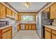 Bright kitchen featuring light wood cabinetry, white appliances, and a stainless steel refrigerator at 1115 Lake Francis Dr, Apopka, FL 32712