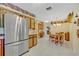 A kitchen features a dining area, desk and storage, and stainless steel refrigerator at 1115 Lake Francis Dr, Apopka, FL 32712