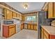 Bright kitchen featuring light wood cabinetry, white appliances, and a stainless steel refrigerator at 1115 Lake Francis Dr, Apopka, FL 32712