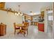 Eat-in kitchen featuring tile floors, wood cabinets, white appliances, and a breakfast nook at 1115 Lake Francis Dr, Apopka, FL 32712