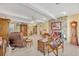 Well-lit living room with tile floors, a stone fireplace, and an assortment of classic wood furnishings at 1115 Lake Francis Dr, Apopka, FL 32712