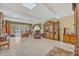Open-concept living room with tile flooring, skylight, ceiling fan, and classic wood furnishings at 1115 Lake Francis Dr, Apopka, FL 32712