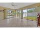 Bright sunroom with tiled flooring, ceiling fan, and wall-to-wall sliding glass doors at 1115 Lake Francis Dr, Apopka, FL 32712