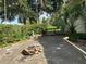 Backyard showcasing a brick patio, mature trees, and landscaping at 116 Oakmont Ln, New Smyrna Beach, FL 32168
