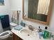 Well-lit bathroom featuring a vanity with a sink, decorative towels, and coordinated accessories at 116 Oakmont Ln, New Smyrna Beach, FL 32168