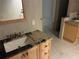 Bathroom featuring a wooden vanity with granite countertop and tile flooring at 116 Oakmont Ln, New Smyrna Beach, FL 32168