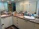 Bathroom with double sink vanity, granite countertops, decorative mirrors and lighting at 116 Oakmont Ln, New Smyrna Beach, FL 32168