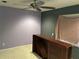Bedroom with lavender wall paint, built-in wooden shelving and ceiling fan at 116 Oakmont Ln, New Smyrna Beach, FL 32168