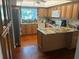 Well-equipped kitchen features granite countertops, modern appliances, and warm wood cabinets at 116 Oakmont Ln, New Smyrna Beach, FL 32168