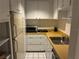 Compact kitchen featuring white appliances, wood countertops, and essential amenities at 116 Oakmont Ln, New Smyrna Beach, FL 32168