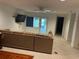 Spacious living room with neutral carpet, ceiling fan, and sliding glass door leading to the porch at 116 Oakmont Ln, New Smyrna Beach, FL 32168