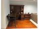 Home office space with wooden desk and storage with orange hardwood flooring at 116 Oakmont Ln, New Smyrna Beach, FL 32168