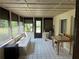 Enclosed porch featuring tile flooring, ample sunlight, and outdoor access, perfect for entertaining at 116 Oakmont Ln, New Smyrna Beach, FL 32168