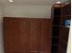 Spare bedroom featuring built-in Murphy bed and wooden shelving unit at 116 Oakmont Ln, New Smyrna Beach, FL 32168