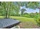 The spacious backyard offers a wooden deck with a lush green lawn, perfect for outdoor activities at 1161 Dot Dr, Altamonte Springs, FL 32714