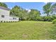 Expansive backyard with lush green grass and mature trees, perfect for outdoor activities and relaxation at 1161 Dot Dr, Altamonte Springs, FL 32714