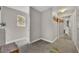 Hallway with carpet, closet with mirrored doors, geometric wall art, providing functional access to rooms at 1161 Dot Dr, Altamonte Springs, FL 32714