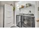 Convenient laundry room featuring modern washer and dryer, along with storage shelves for efficient organization and functionality at 1161 Dot Dr, Altamonte Springs, FL 32714