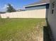 Spacious, partially-grassed backyard enclosed by a pristine, well-maintained fence, offering privacy at 1193 Catskill Dr, Haines City, FL 33844
