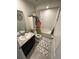 Bright bathroom with a shower-tub combo, modern vanity, and decorative accents at 1193 Catskill Dr, Haines City, FL 33844