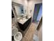 This bathroom offers double sinks, granite countertops, a large mirror, and soft, neutral colors at 1193 Catskill Dr, Haines City, FL 33844