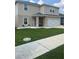 Inviting home with a charming front porch featuring a hanging chair and tidy landscaping at 1193 Catskill Dr, Haines City, FL 33844