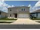 Charming two-story home with a well-manicured lawn and a welcoming front entrance at 1193 Catskill Dr, Haines City, FL 33844