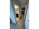 Hallway with a view of the bathroom with double sinks and a fully stocked walk-in closet at 1193 Catskill Dr, Haines City, FL 33844