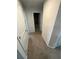 Hallway leading to bathroom featuring neutral walls and carpet at 1193 Catskill Dr, Haines City, FL 33844