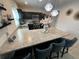 Well-lit kitchen with stainless steel appliances, pendant lighting, and a breakfast bar at 1193 Catskill Dr, Haines City, FL 33844