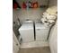 Clean laundry room with modern washer and dryer and storage space at 1193 Catskill Dr, Haines City, FL 33844
