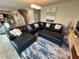 Stylish living room featuring a sectional sofa, rug, and modern lighting fixtures at 1193 Catskill Dr, Haines City, FL 33844