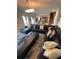 Open-concept living room with a sectional sofa and views into dining area and kitchen at 1193 Catskill Dr, Haines City, FL 33844
