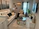 Bright living room with white sofas, patterned rug, and modern lighting at 1193 Catskill Dr, Haines City, FL 33844