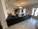 Spacious living room featuring a modern sectional sofa and large television at 1193 Catskill Dr, Haines City, FL 33844