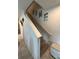 Carpeted staircase with white railing and decorative wall art, leading to the upper level of the home at 1193 Catskill Dr, Haines City, FL 33844