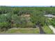Aerial view of a wooded property with long driveway showcasing the privacy and seclusion at 127 Oak Ln, Ormond Beach, FL 32174