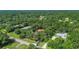 Aerial view of a wooded property highlighting its location and proximity to neighboring homes at 127 Oak Ln, Ormond Beach, FL 32174