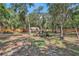 Expansive backyard featuring mature trees, wooden fence, shed, and garden area offering privacy and outdoor enjoyment at 127 Oak Ln, Ormond Beach, FL 32174