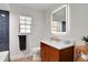 This bathroom features a wood vanity with a marble top, modern fixtures, and a LED illuminated mirror at 127 Oak Ln, Ormond Beach, FL 32174