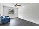 This room is bright and spacious, with gray floors and a large window. Includes a comfortable-looking blue sofa at 127 Oak Ln, Ormond Beach, FL 32174