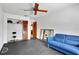 This room is bright and spacious, with gray floors. Includes a comfortable-looking blue sofa and workout equipment at 127 Oak Ln, Ormond Beach, FL 32174