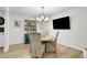Cozy dining area with wicker chairs, a round table, and a view to the yard at 127 Oak Ln, Ormond Beach, FL 32174