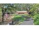 Beautiful single-story home with mature trees, long driveway and well manicured lawn at 127 Oak Ln, Ormond Beach, FL 32174