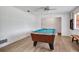 Bright game room featuring a billiard table, wood floors, and a bench along the wall at 127 Oak Ln, Ormond Beach, FL 32174