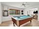 Bright game room with a pool table, ceiling fan, tile floors and an open view to the dining area at 127 Oak Ln, Ormond Beach, FL 32174