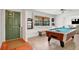 Bright game room with a pool table, tile floors, and a view of the outdoor scenery at 127 Oak Ln, Ormond Beach, FL 32174