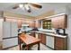 Traditional kitchen with wood cabinets, a movable island, and stainless appliances at 127 Oak Ln, Ormond Beach, FL 32174